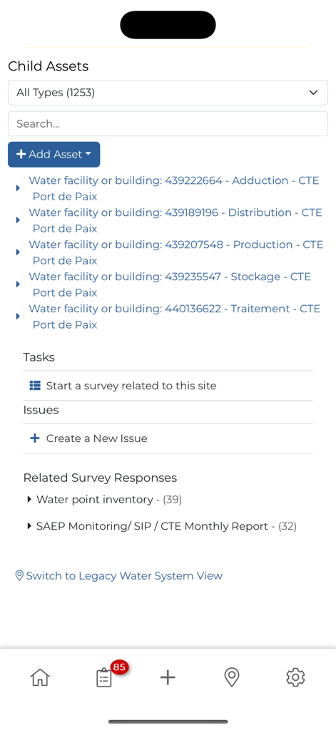 mWater Surveyor - Interface of the mWater Surveyor app displaying a list of child assets for water facilities and options to start surveys or report issues