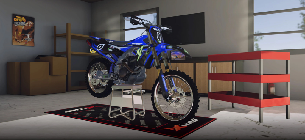 A customized blue and black motocross bike on a stand inside a garage workshop in SMX Supermoto Vs Motocross.