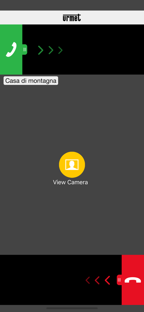 Urmet CallMe - Pantalla de la app Urmet CallMe mostrando una llamada entrante del videoportero para una casa en la montaña con opción de cámara de vista