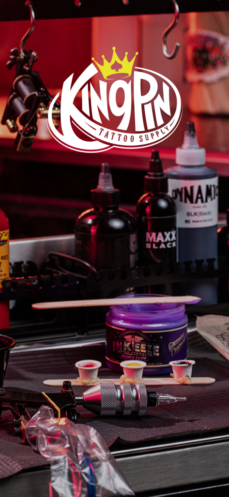 Kingpin Tattoo Supply logo on a workstation with professional tattoo inks and equipment