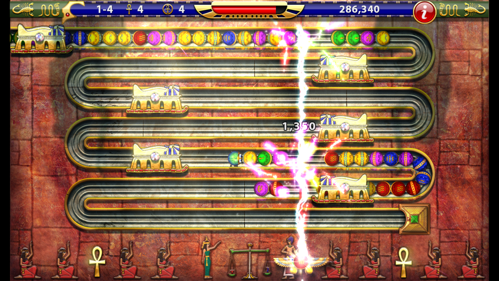 Luxor HD - Gameplay screenshot of Luxor HD featuring colored spheres on an Egyptian themed track with a lightning bolt power up effect
