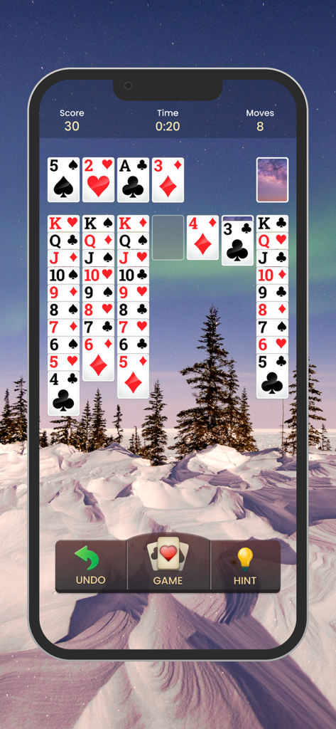 Solitaire card game interface with a beautiful snowy winter landscape background.