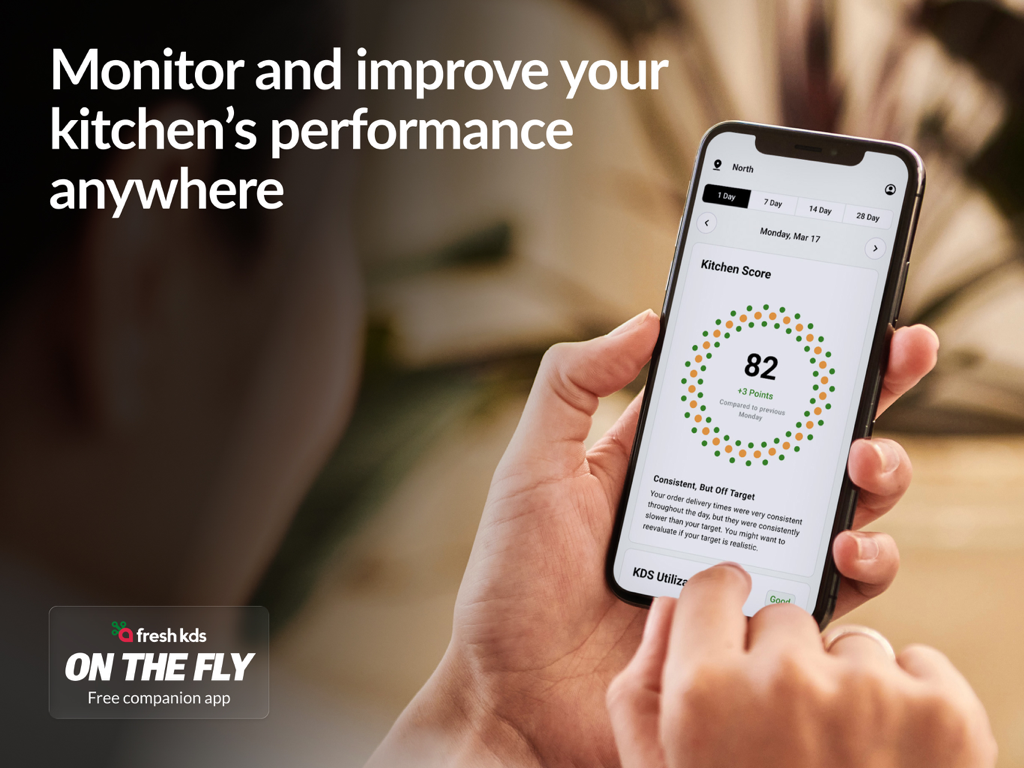 Fresh KDS | #1 Kitchen Display - A person holding a smartphone showing kitchen performance analytics and scores in the Fresh KDS app.