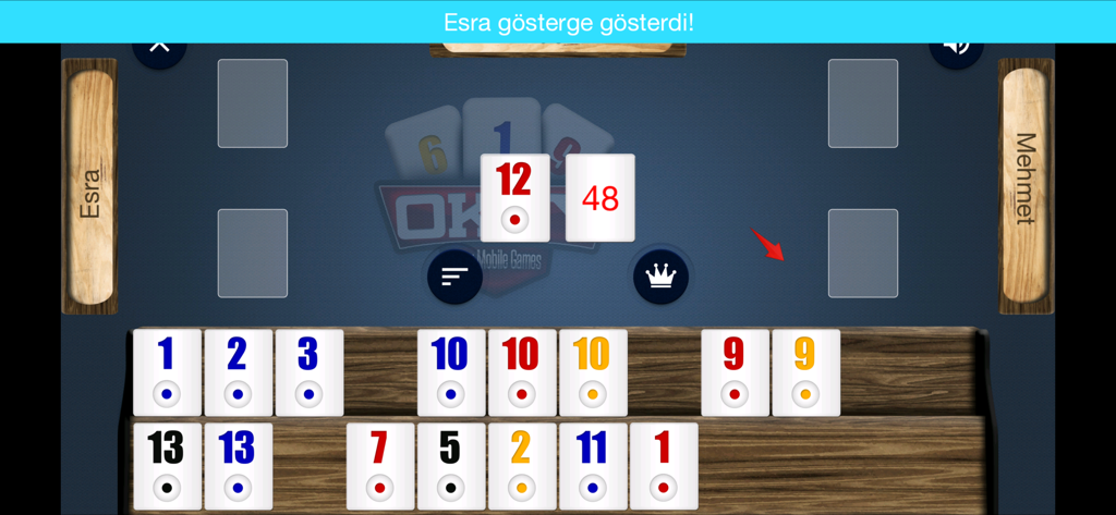 A gameplay screen of the Okey game showing numbered tiles on a wooden rack and a digital table layout.