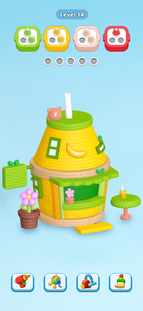 Gameplay of Knit Away featuring a colorful knitted house and yarn sorting puzzle.