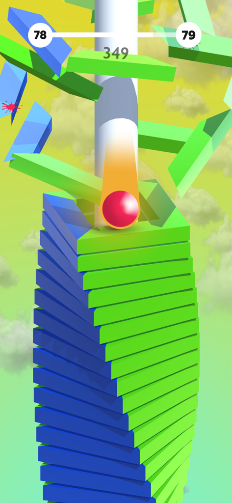 Una bola roja saltando a través de una torre espiral de plataformas azules y verdes en el juego Bounzy Ballz.