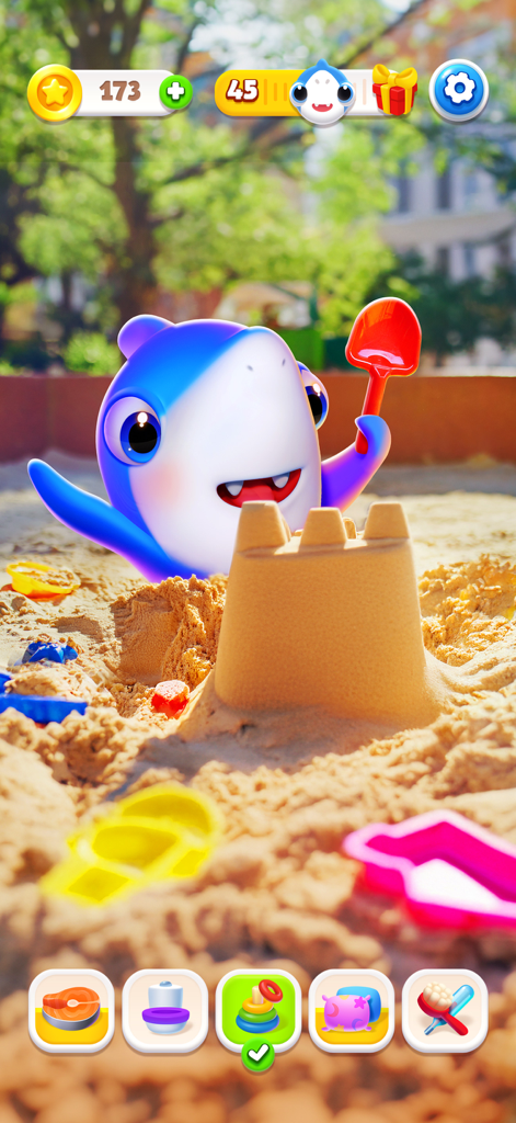 A cute blue virtual pet shark building a sandcastle with a red shovel in a sunny sandbox.