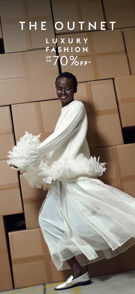 THE OUTNET: Luxury for less - A woman in a stylish white fringe sweater and skirt posing in front of cardboard boxes with text for The Outnet 70 percent off sale.
