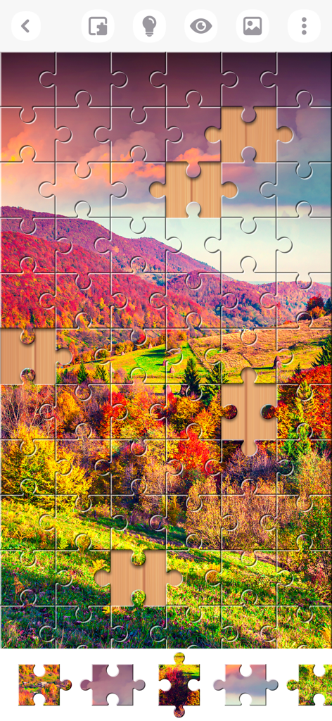 Jigsaw Puzzles Explorer - Gameplay-Bildschirm, der ein farbenfrohes Herbstberglandschafts-Puzzle in Arbeit zeigt.