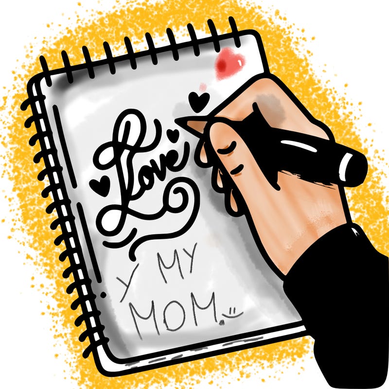 a hand writing “love” in calligraphy on a notebook