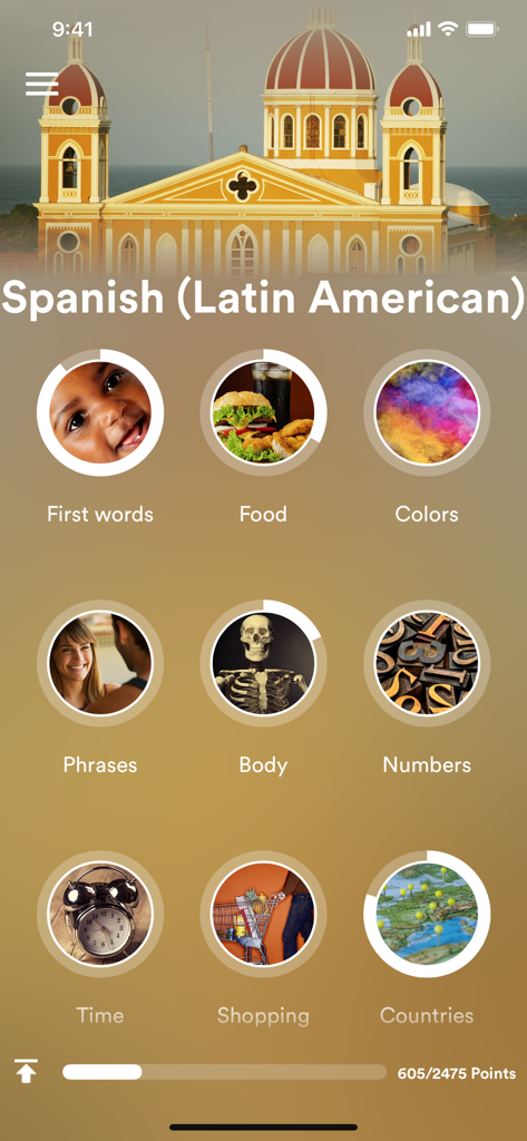 Main menu of the Spanish learning app showing topics like food phrases and numbers