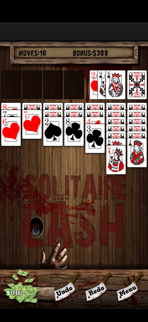 Solitaire Cash - Solitaire Cash gameplay screen featuring a horror themed background and cleaver shaped buttons