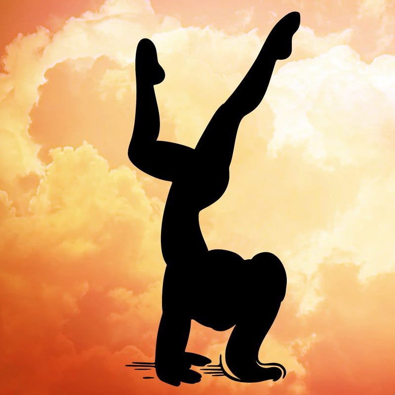 girl wearing a leotard doing a handstand