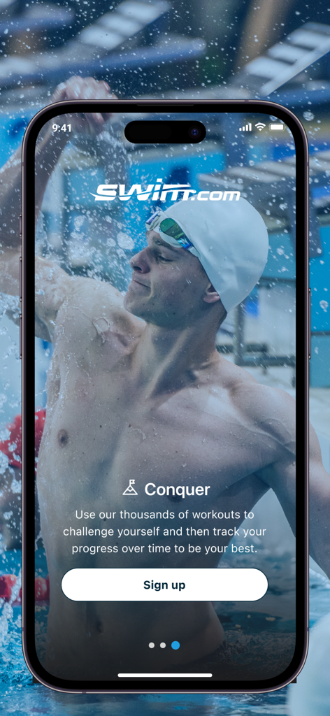 A male swimmer in a pool on the Swim.com app onboarding screen featuring a sign up button