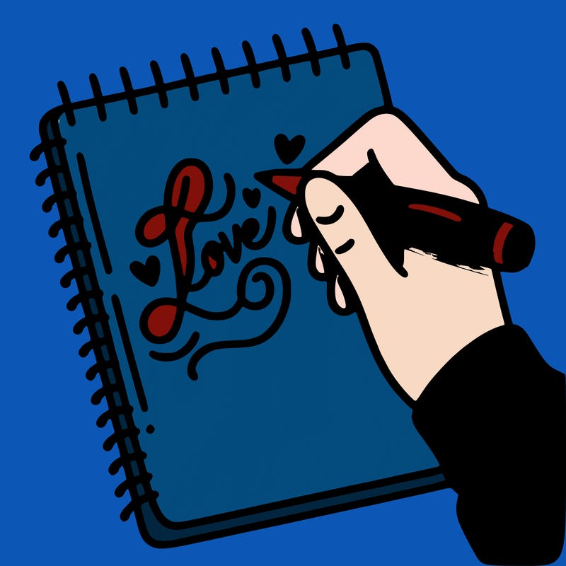 a hand writing “love” in calligraphy on a notebook