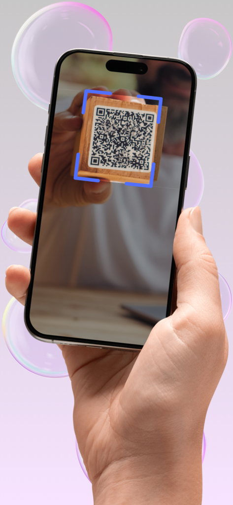 A hand holding an iPhone to scan a WiFi QR code printed on a wooden block