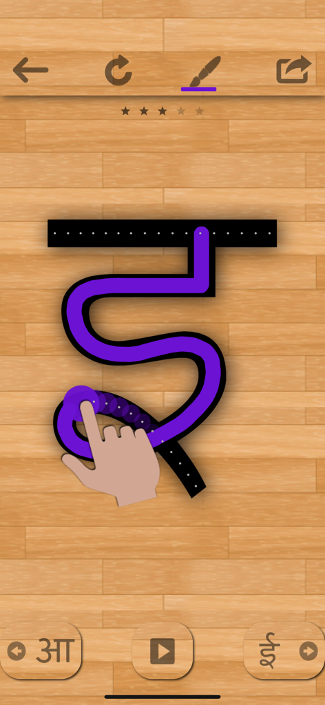 Una mano trazando un carácter hindi en la aplicación de aprendizaje Hindi 101.