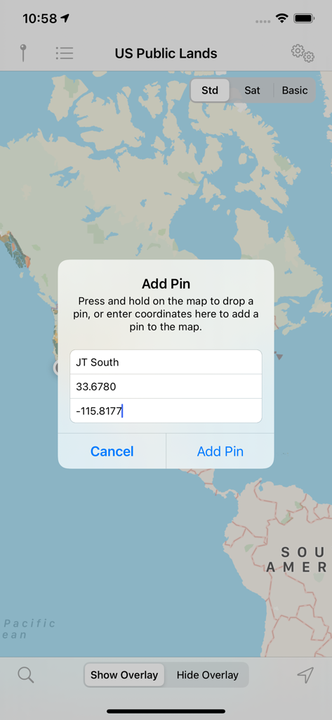 Interface of the US Public Lands app showing a map of North America with a pop-up dialog to add a location pin using GPS coordinates.
