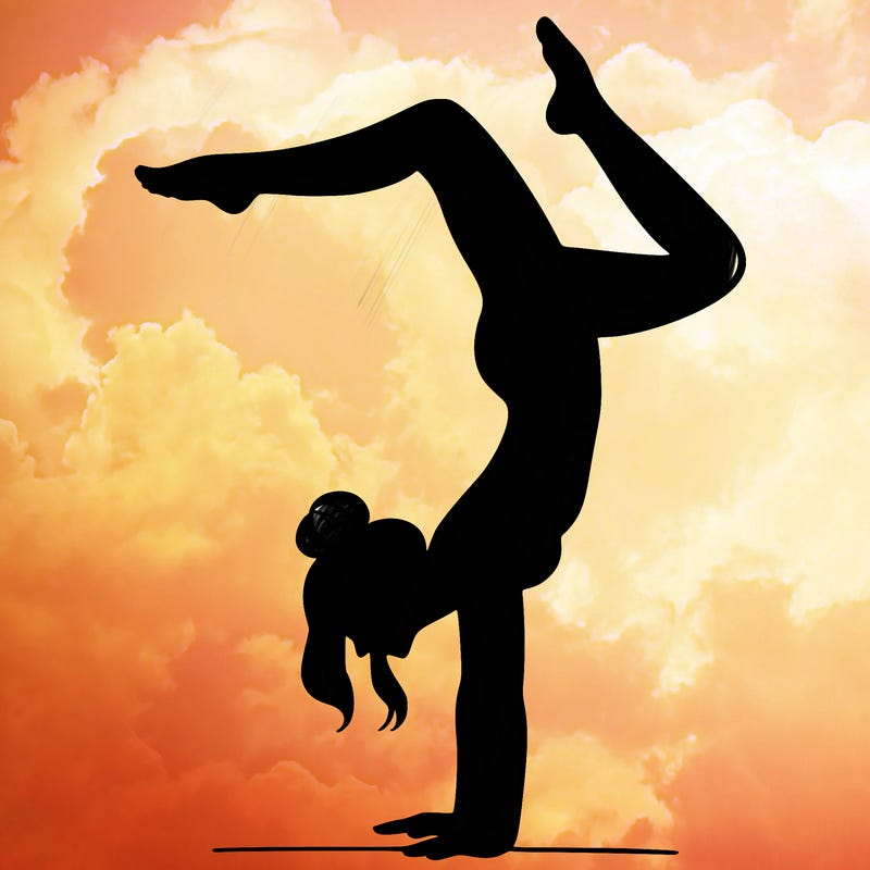 a woman doing a handstand