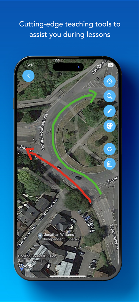 A satellite map showing a roundabout with red and green directional arrows as a driving lesson teaching tool