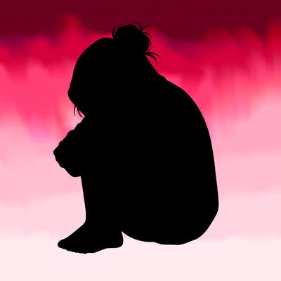 girl crying with hoodie over her hair and hair in bun