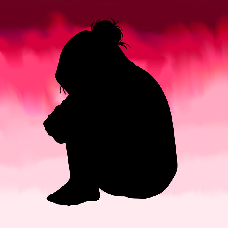 girl crying with hoodie over her hair and hair in bun
