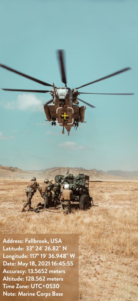 A photo showing a helicopter in a field with an overlay of GPS coordinates timestamp and location notes