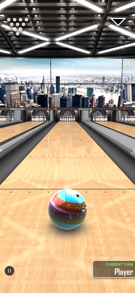 A colorful bowling ball ready for a throw on a realistic 3D lane with a city skyline background.