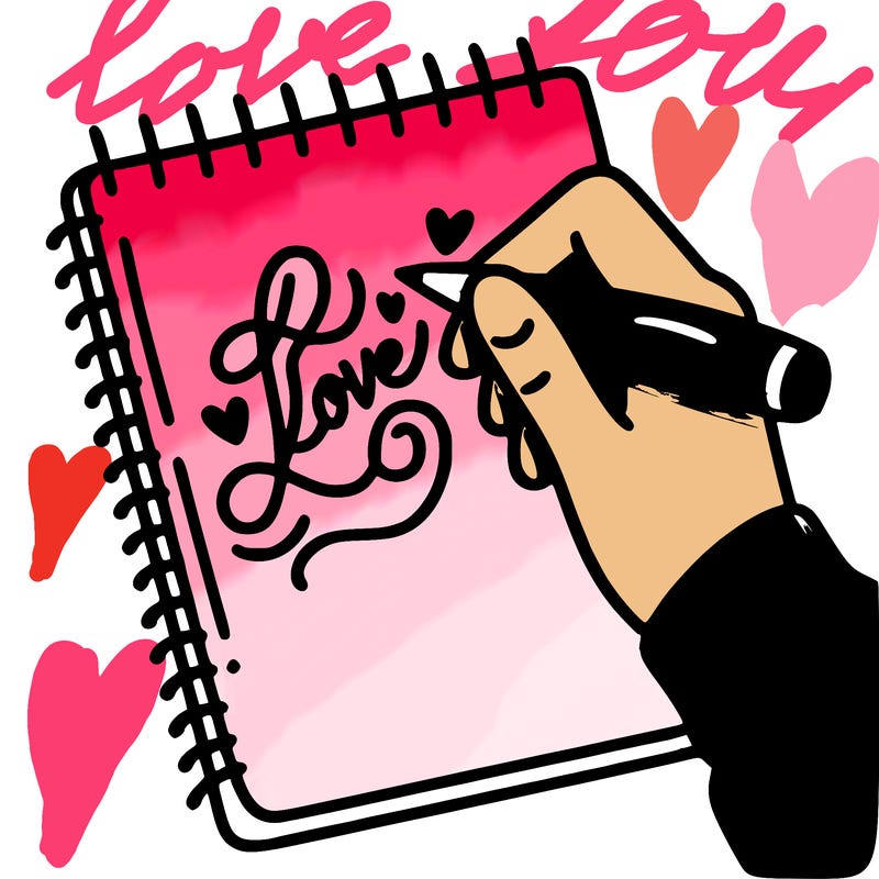 a hand writing “love” in calligraphy on a notebook