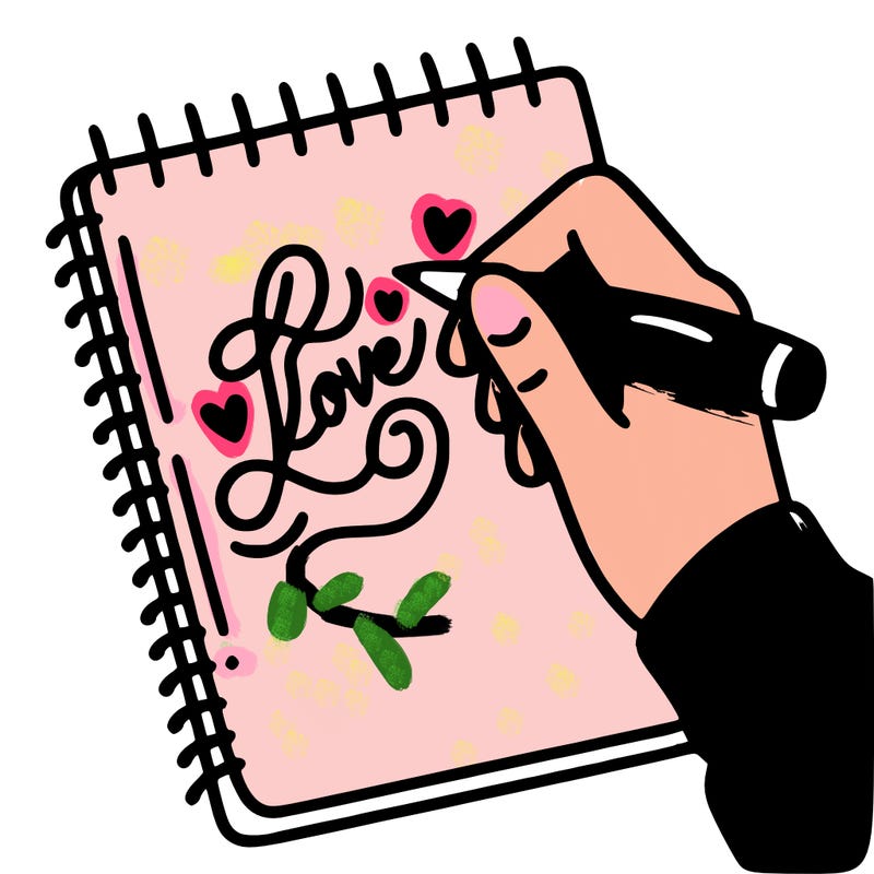 a hand writing “love” in calligraphy on a notebook