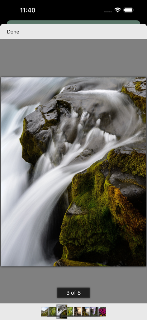 My-Photos - A full screen photo of a waterfall displayed in the My-Photos app with a thumbnail carousel for navigation at the bottom