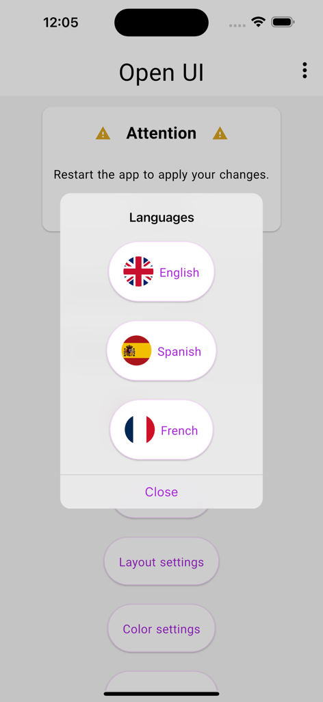 Language selection popup in the Open UI app with flags for English Spanish and French