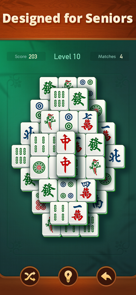 Vita Mahjong gameplay screen featuring large clear tiles designed for seniors on a green background.