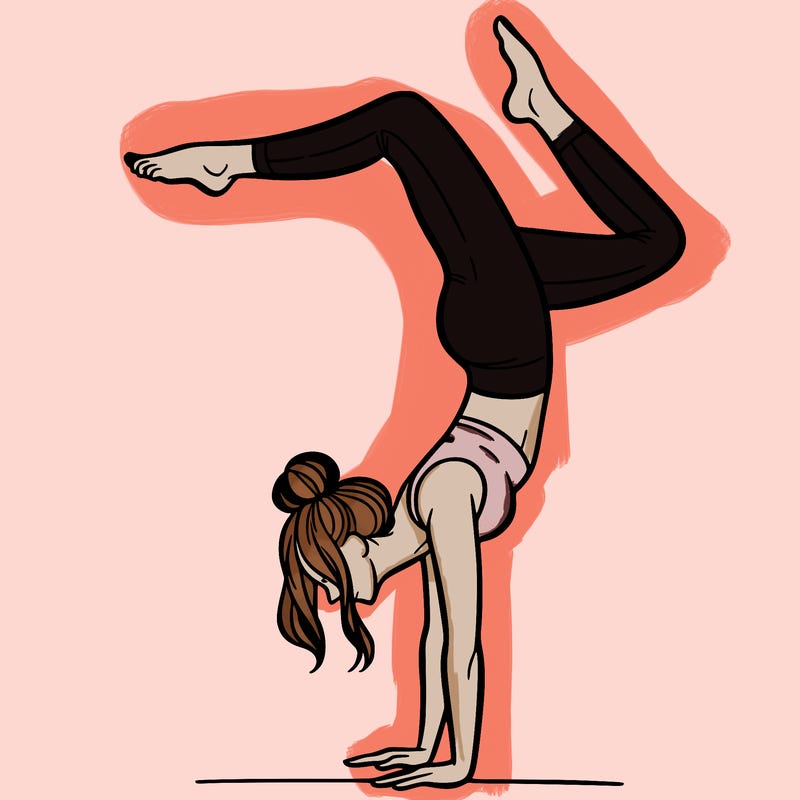 a woman doing a handstand