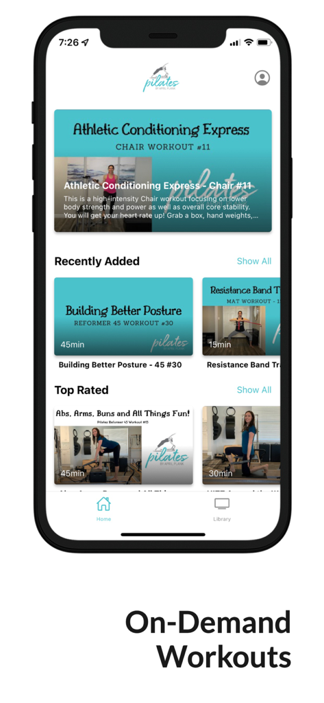 April Plank Pilates - A smartphone showing the April Plank Pilates app interface with a library of on demand workouts for reformer and chair.