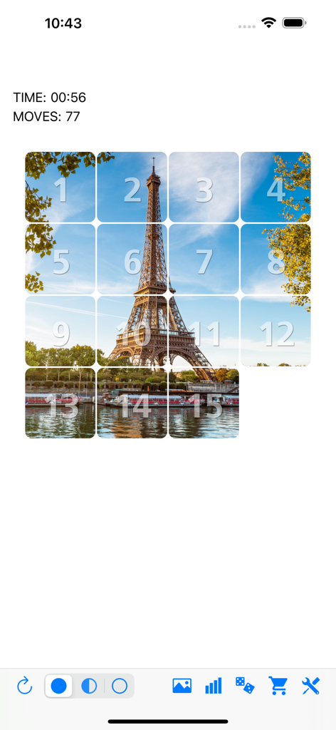 Fifteen sliding tiles puzzle - Juego del Rompecabezas de quince deslizantes que muestra una imagen de la Torre Eiffel y baldosas numeradas.