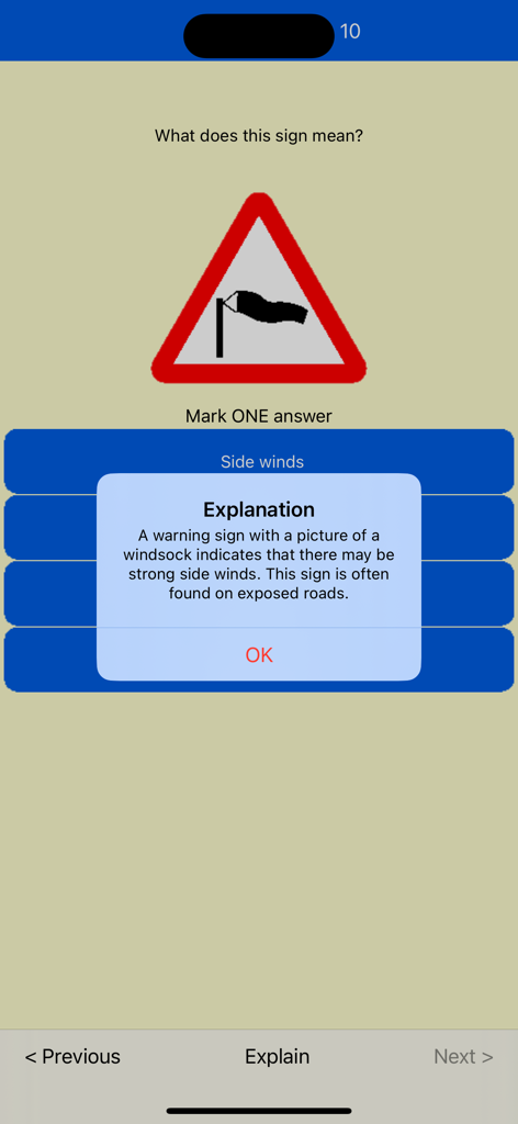 Driving theory test question about a side winds road sign with an explanation pop up