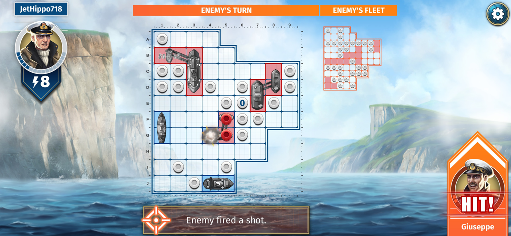 Gameplay of the BATTLESHIP mobile app showing a naval combat grid and a hit on an enemy ship