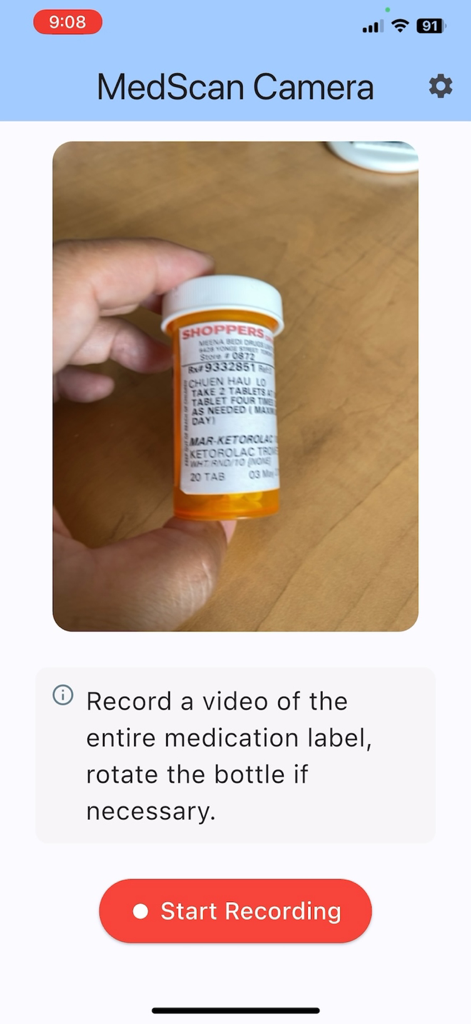 MedScan app camera interface showing a hand holding a prescription bottle for label scanning