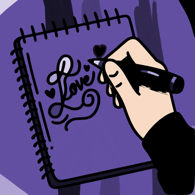 a hand writing “love” in calligraphy on a notebook