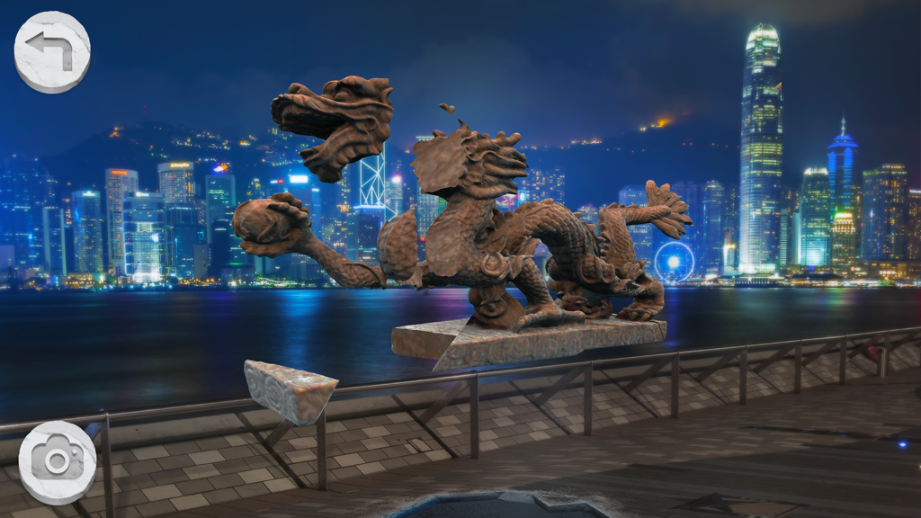 A fragmented 3D dragon sculpture puzzle in an augmented reality cityscape at night.