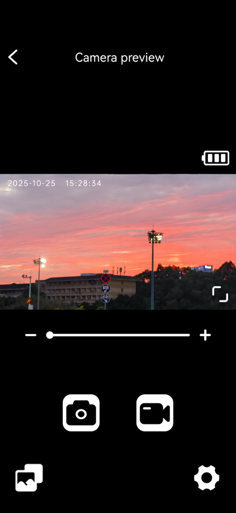 Interface of the Sports-DV app showing a real-time camera preview of a sunset with recording and photo capture controls.