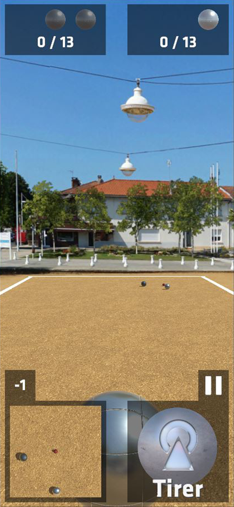 La pétanque - La pétanque mobile game screenshot showing a match on a gravel pitch with a scenic town background.