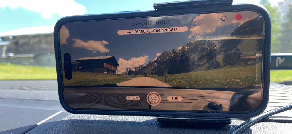 iPhone mounted on a dashboard recording video with DashCam Recorder showing GPS and speed data.