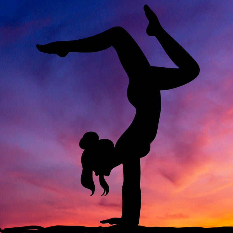 a woman doing a handstand