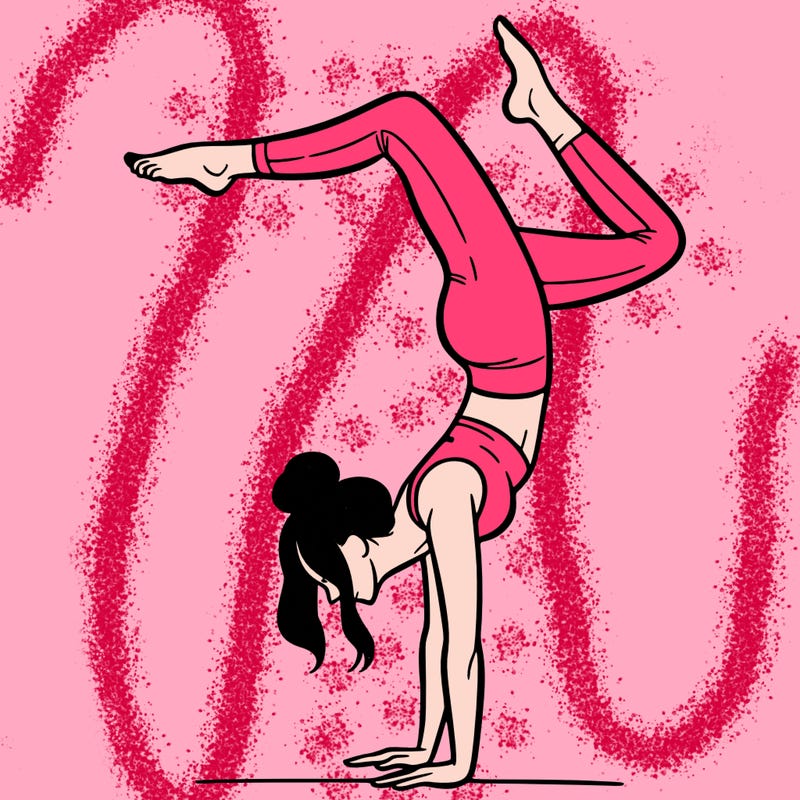 a woman doing a handstand