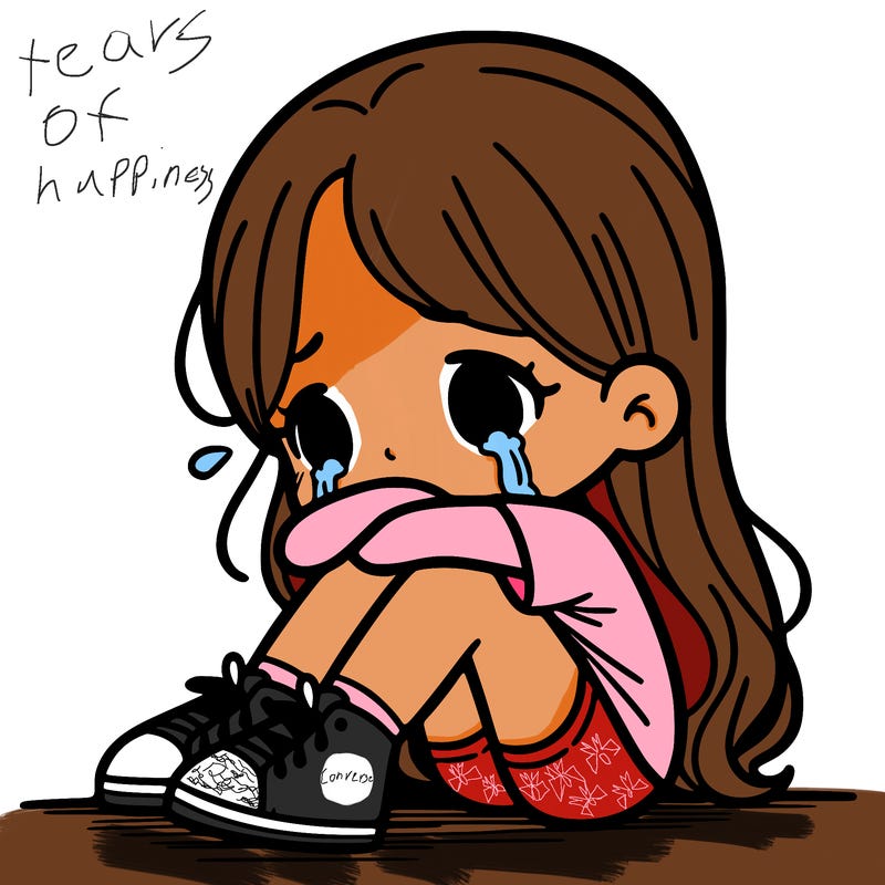 girl sitting with her legs to her chin, crying