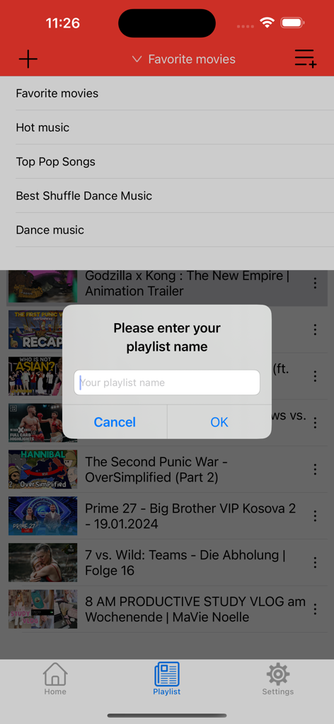 A mobile app interface showing a popup to enter a new playlist name on top of a video list.