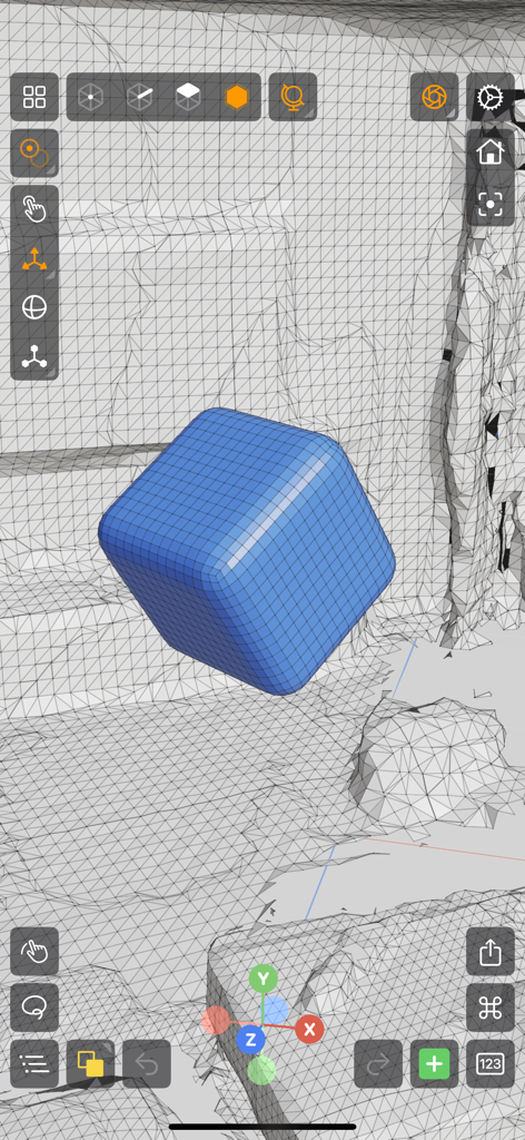 Interfaccia dell'app Valence 3D che mostra un cubo arrotondato blu in fase di modellazione all'interno di un ambiente wireframe