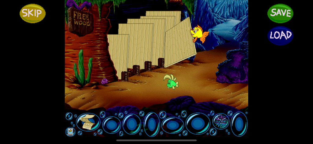Freddi Fish and Luther in an underwater scene with wooden planks and a free wood sign